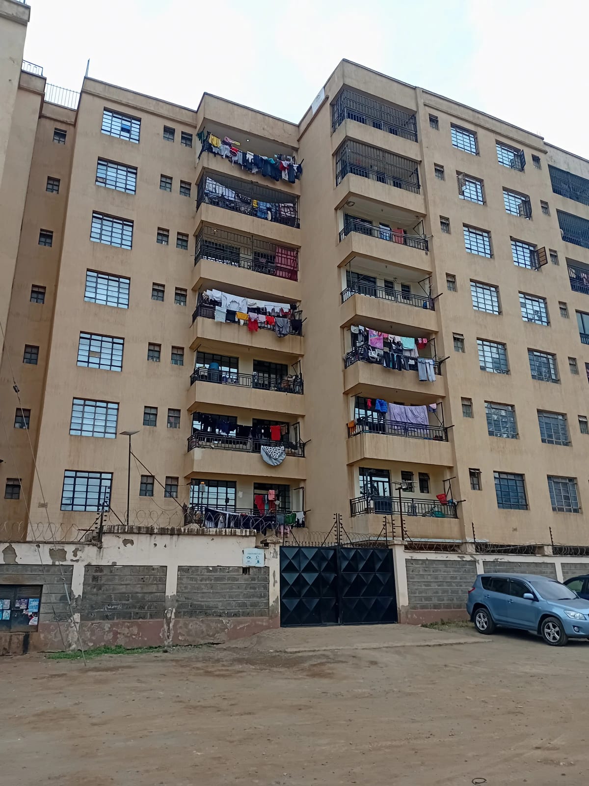 Multi-story residential apartment building with balconies and parking