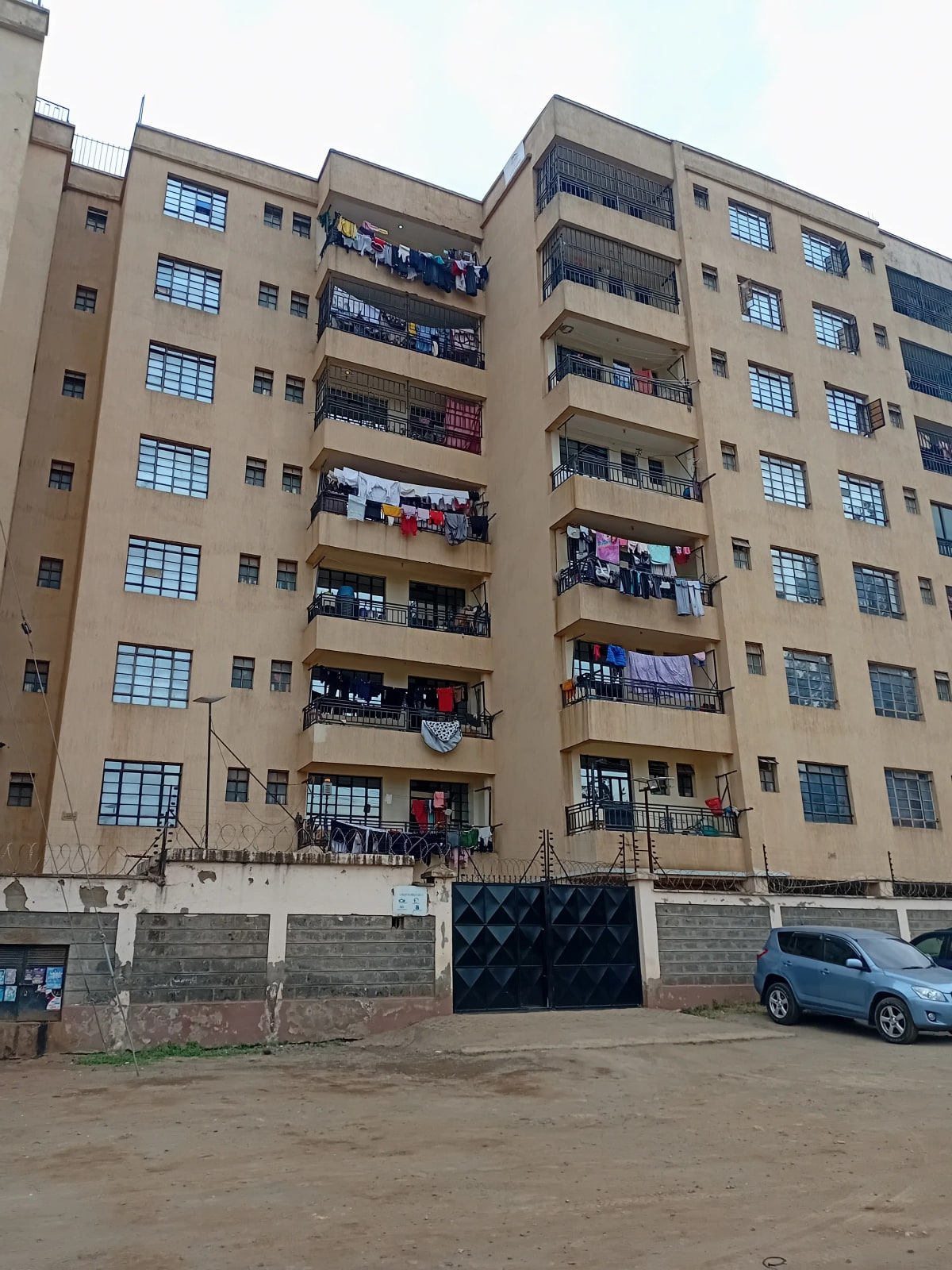 Multi-story residential apartment building with balconies and parking