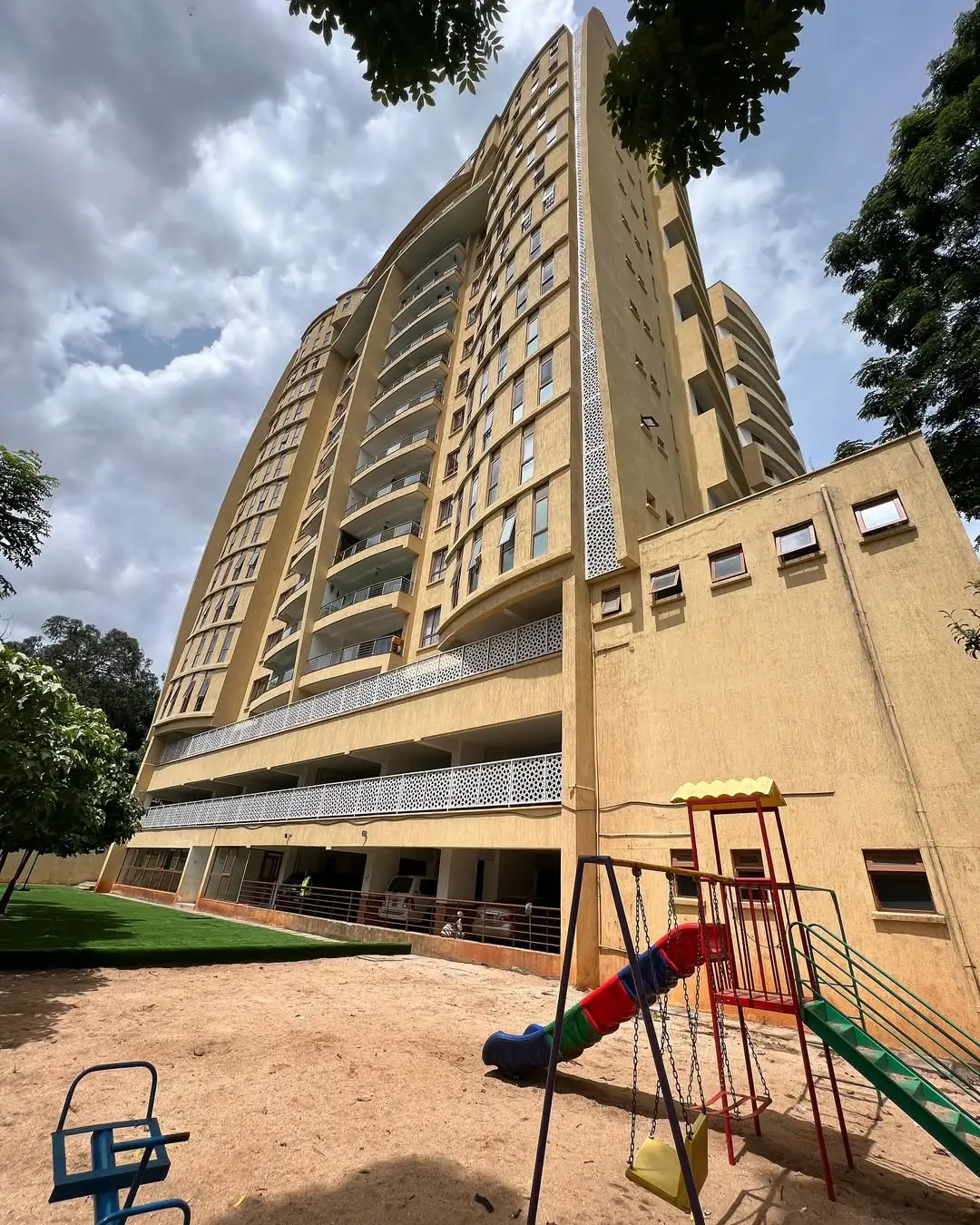 Modern multi-story residential building with compound playground