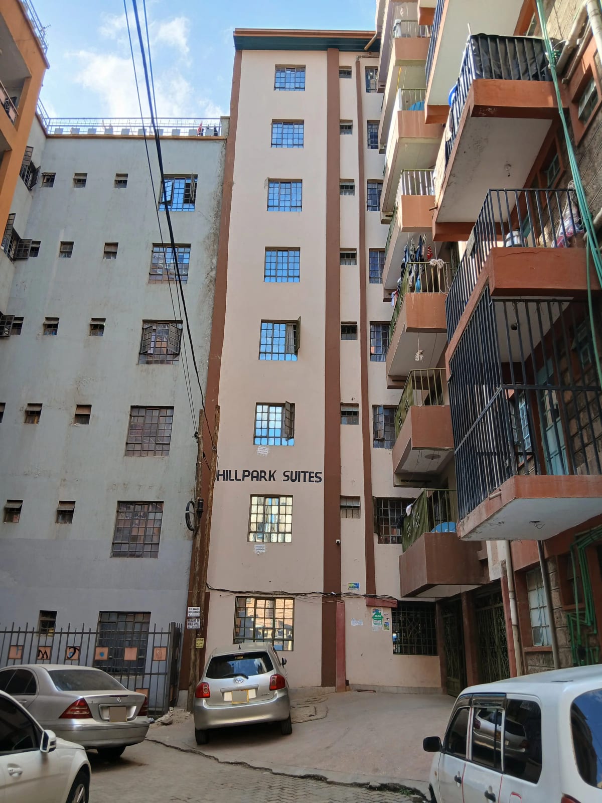 Multi-story residential building facade with ground-level parking