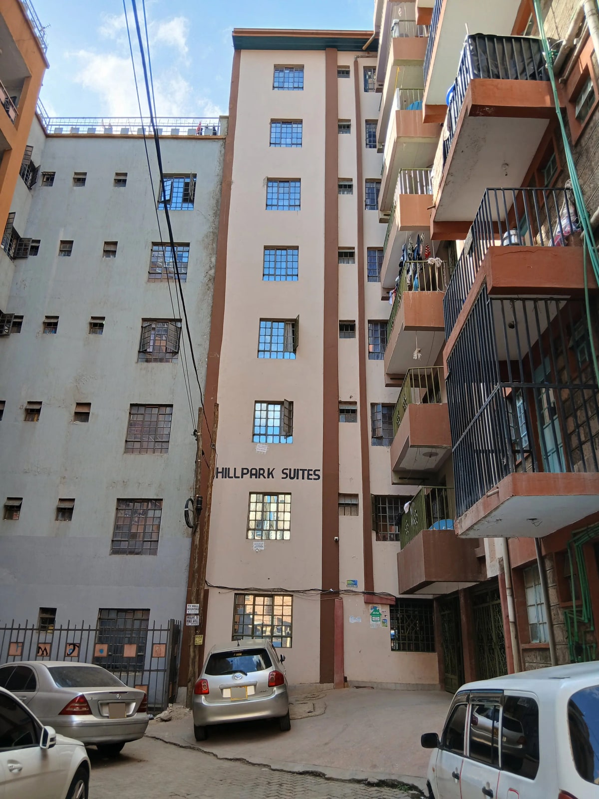 Multi-story residential building facade with ground-level parking