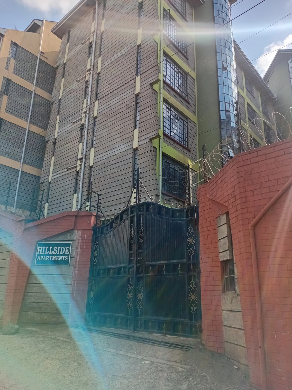 Multi-story apartment building facade with secured entrance gate