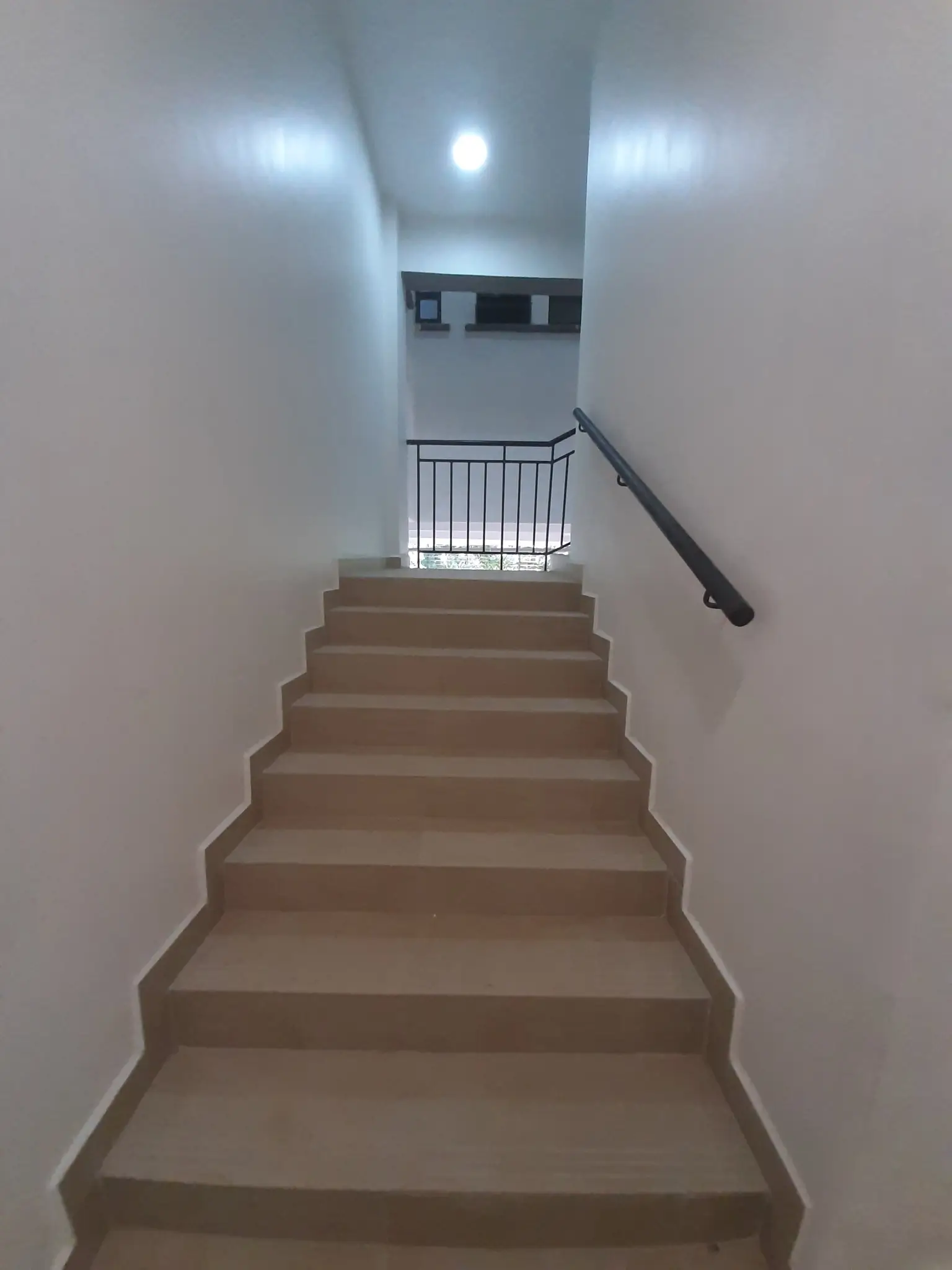 Internal stairwell with metal handrail and LED lighting
