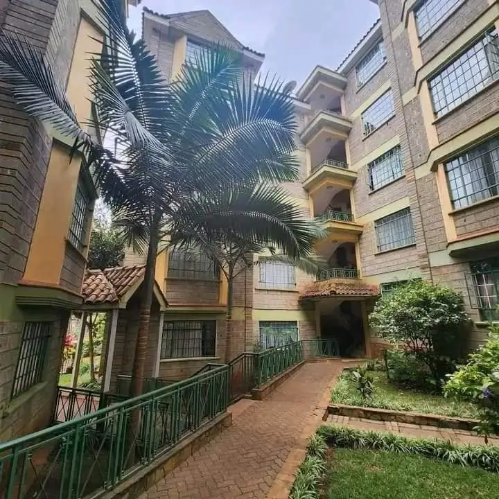 Multi-story apartment building with courtyard and tropical landscaping