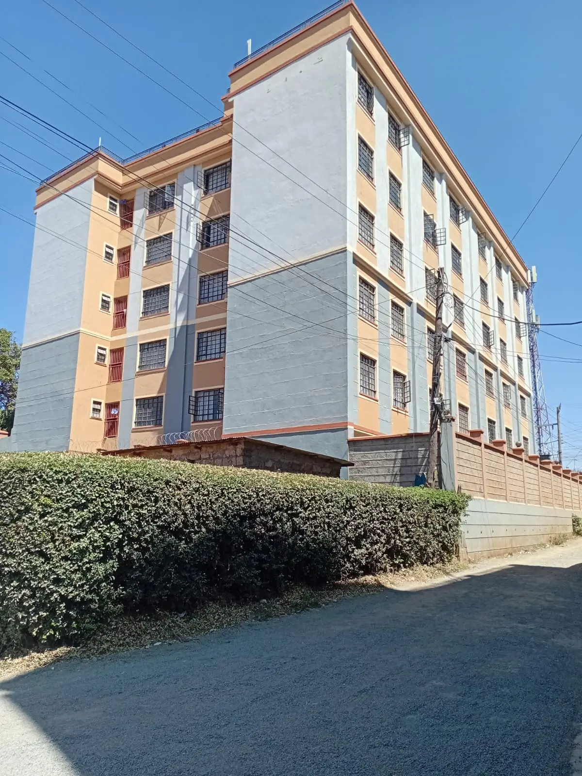 Multi-story residential building with orange and white facade