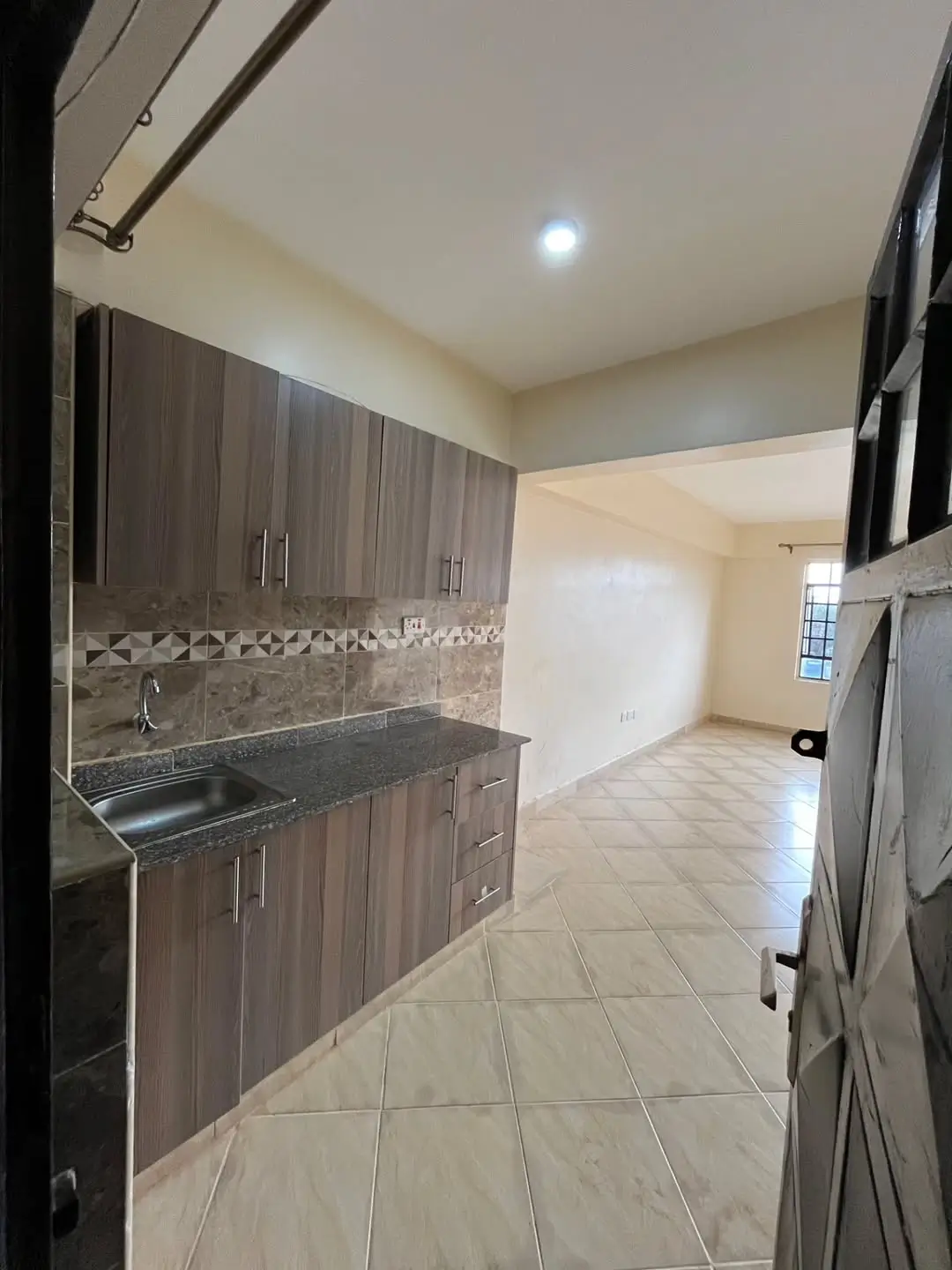 Modern kitchen with dark cabinetry and mosaic backsplash