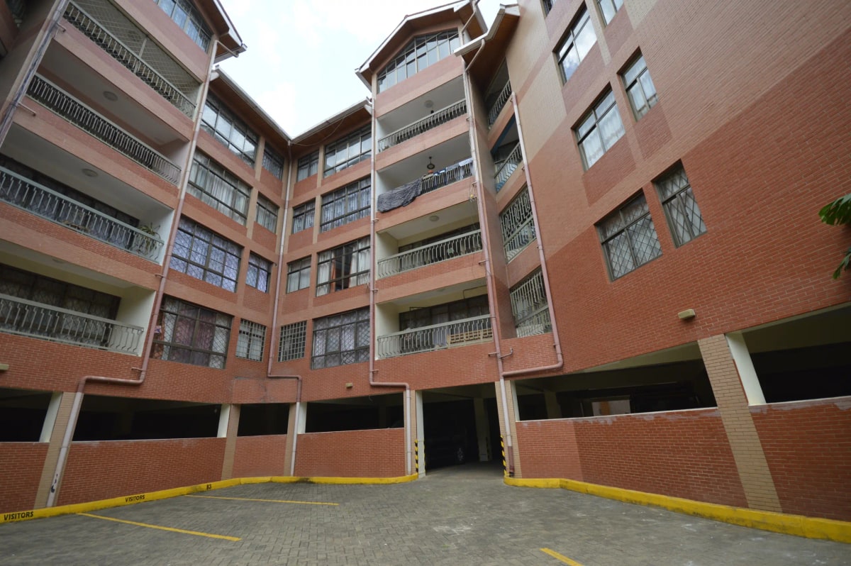 Multi-story apartment complex with underground parking bay