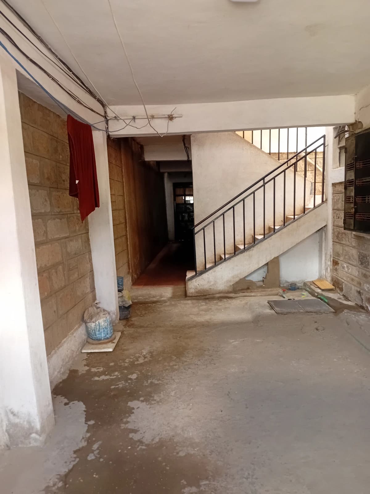 Ground floor lobby with staircase and tiled walls