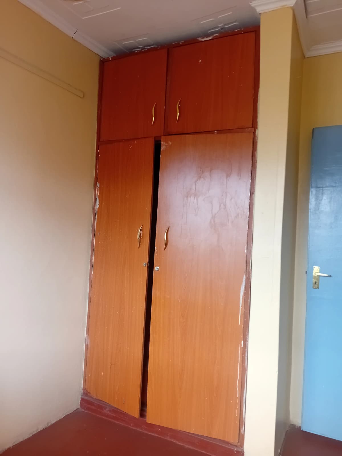 Bedroom with large wooden wardrobe and colorful walls