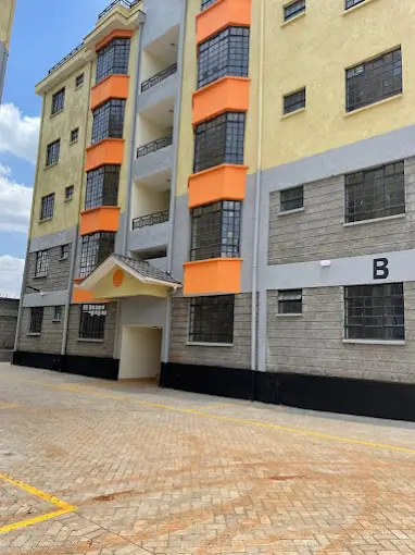 Modern apartment building facade with orange and cream accents