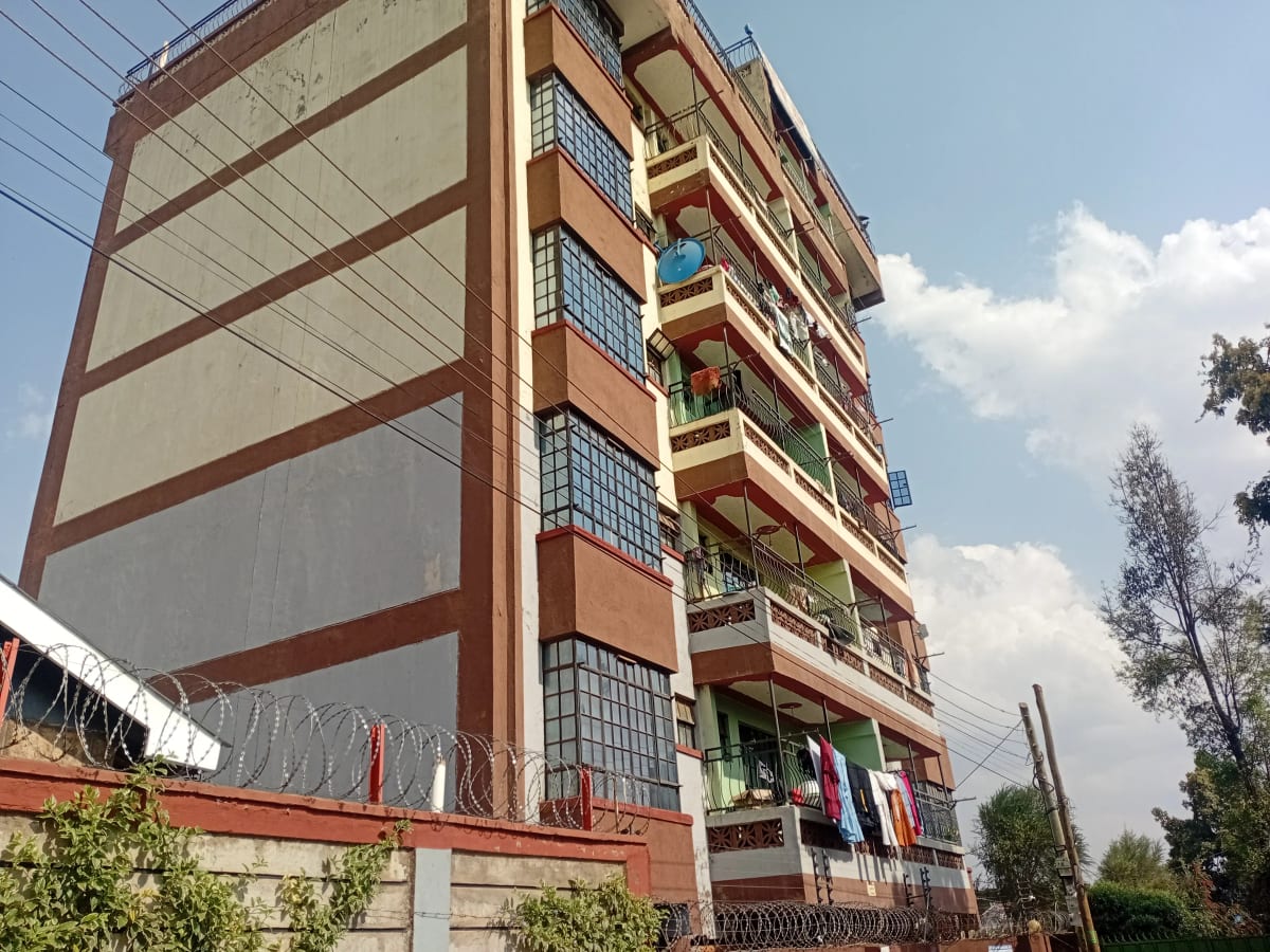Multi-story residential building facade with balconies and clotheslines