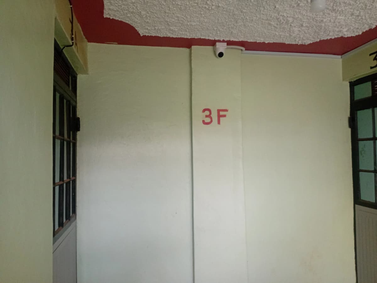 Building corridor with floor marking 3F and red ceiling trim