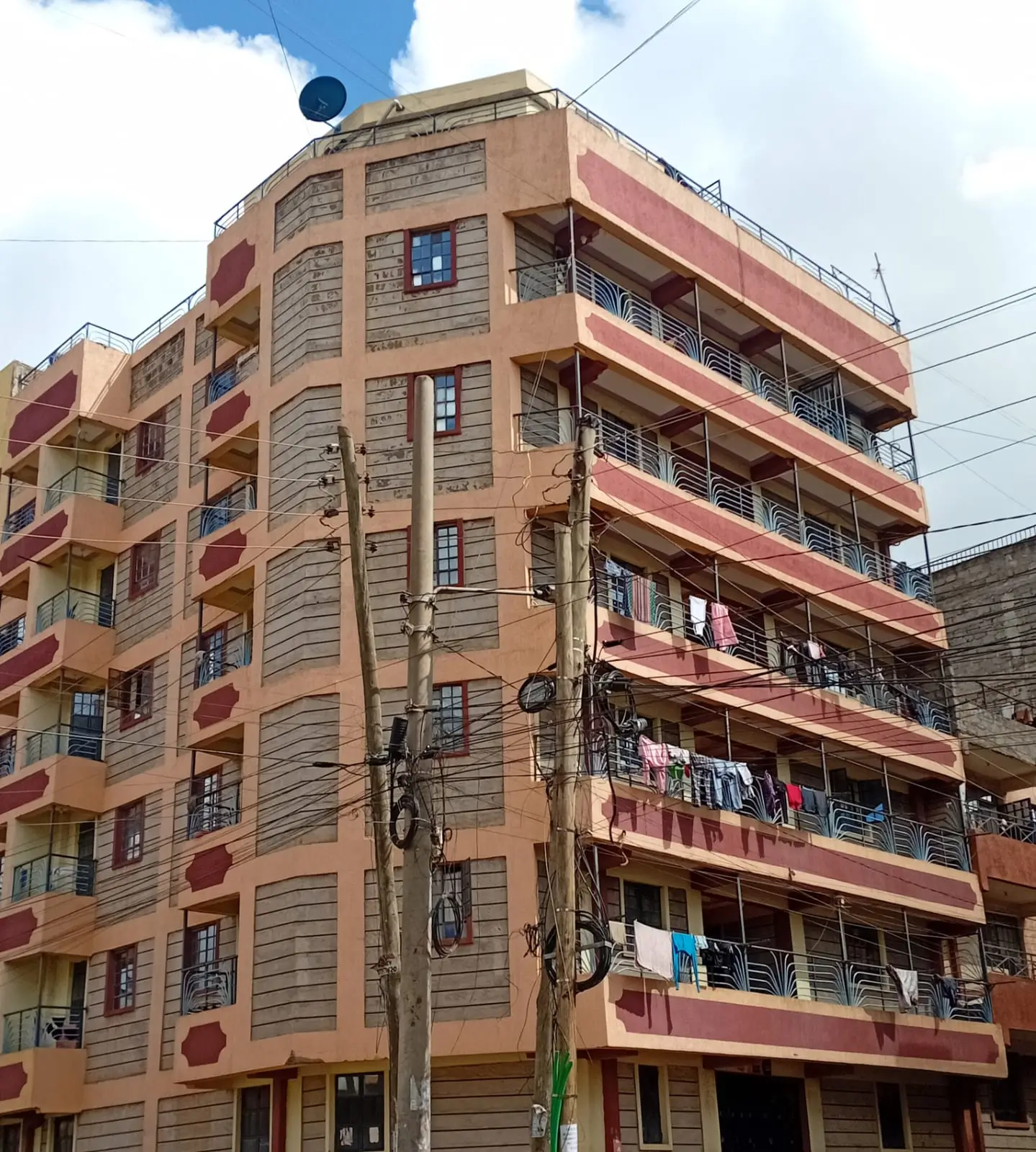 Multi-story residential building facade with balconies and utilities