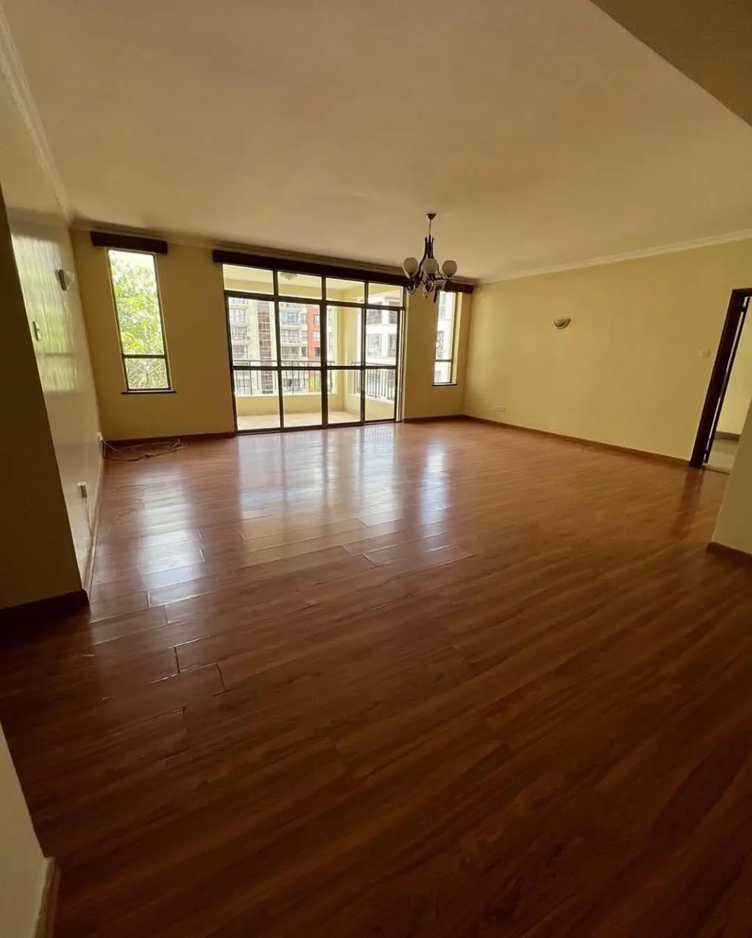 Spacious living room with wooden floors and natural light