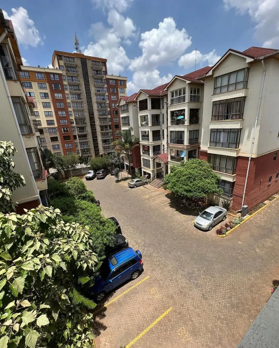 Multi-building residential compound with paved parking area