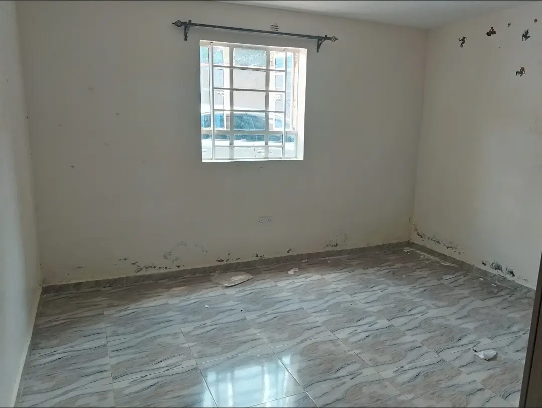 Unfurnished bedroom with wooden flooring and natural light