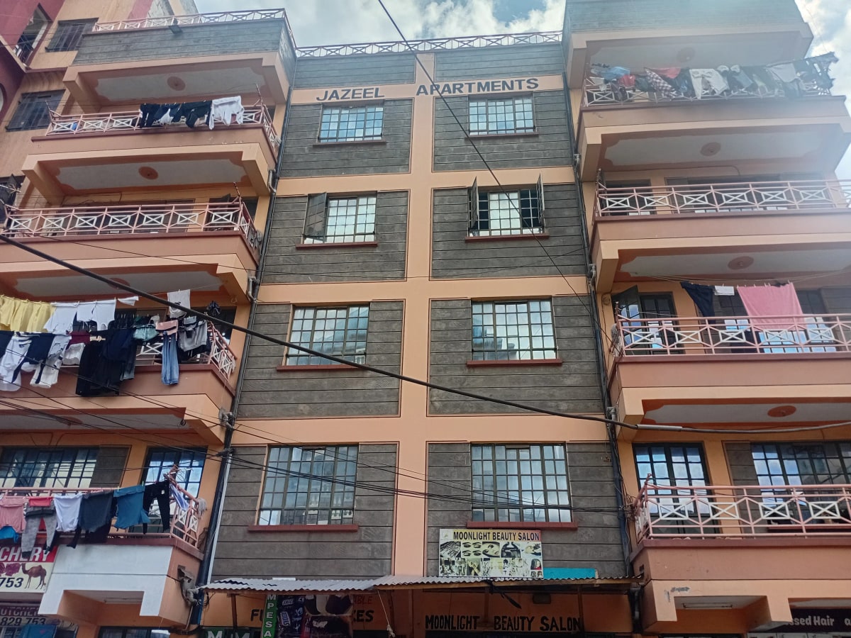 Multi-story apartment building facade with balconies and clotheslines