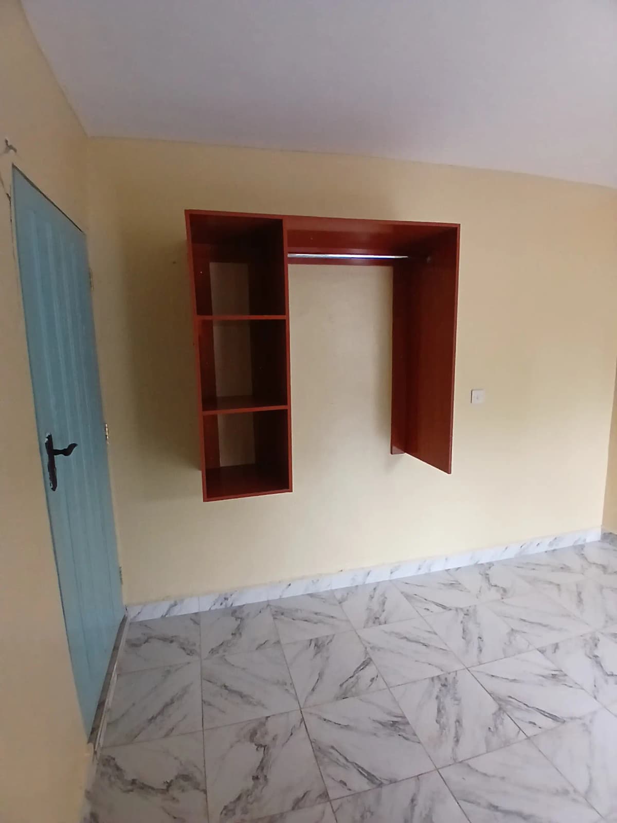 Bedroom with built-in red wooden wardrobe and shelving