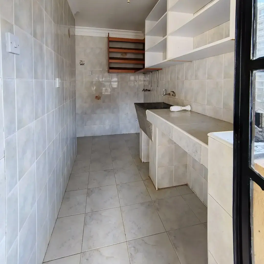Narrow bathroom with dual sink vanity and shower enclosure