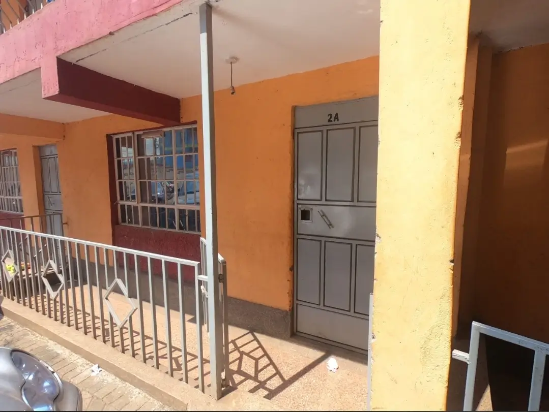 Colorful residential entrance with metal railing and numbered door