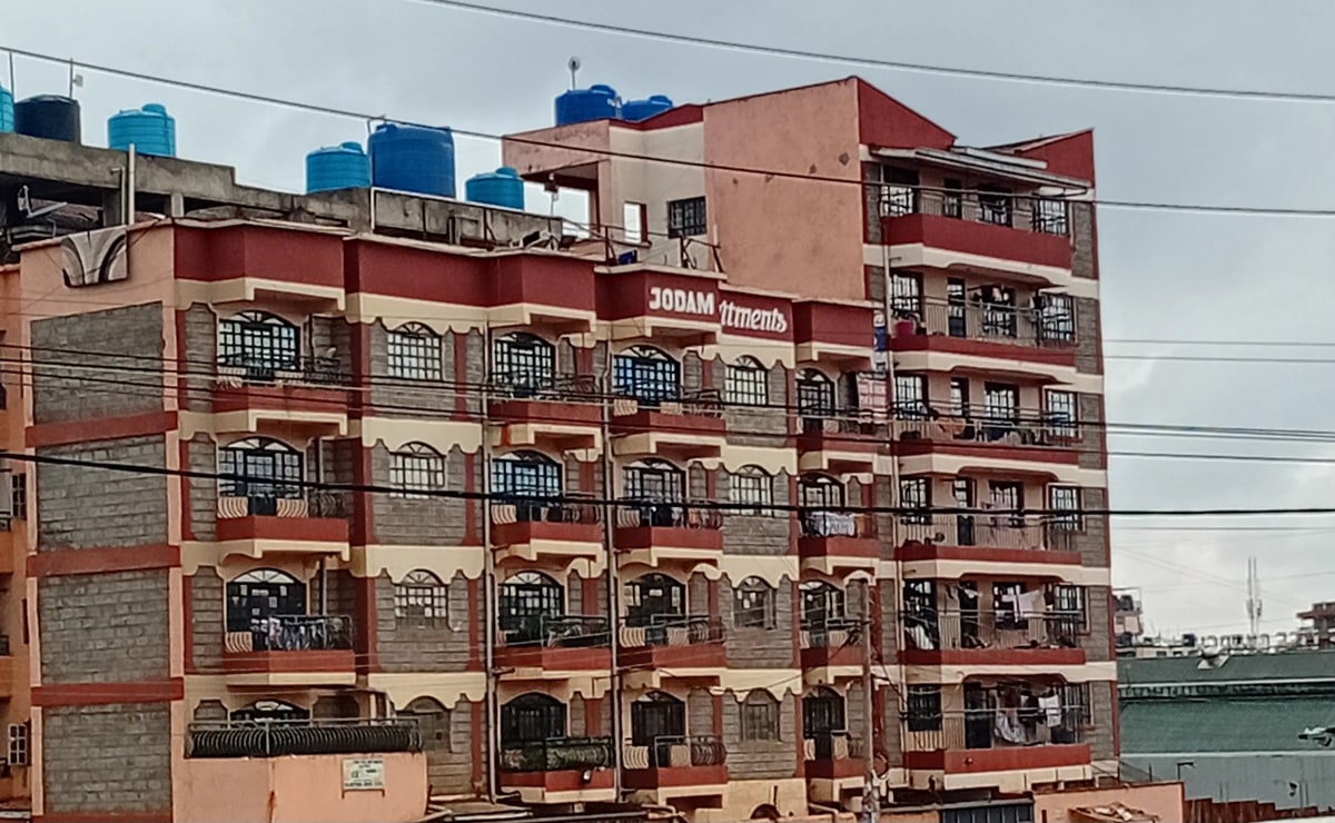 Multi-story residential building facade with red and cream paintwork