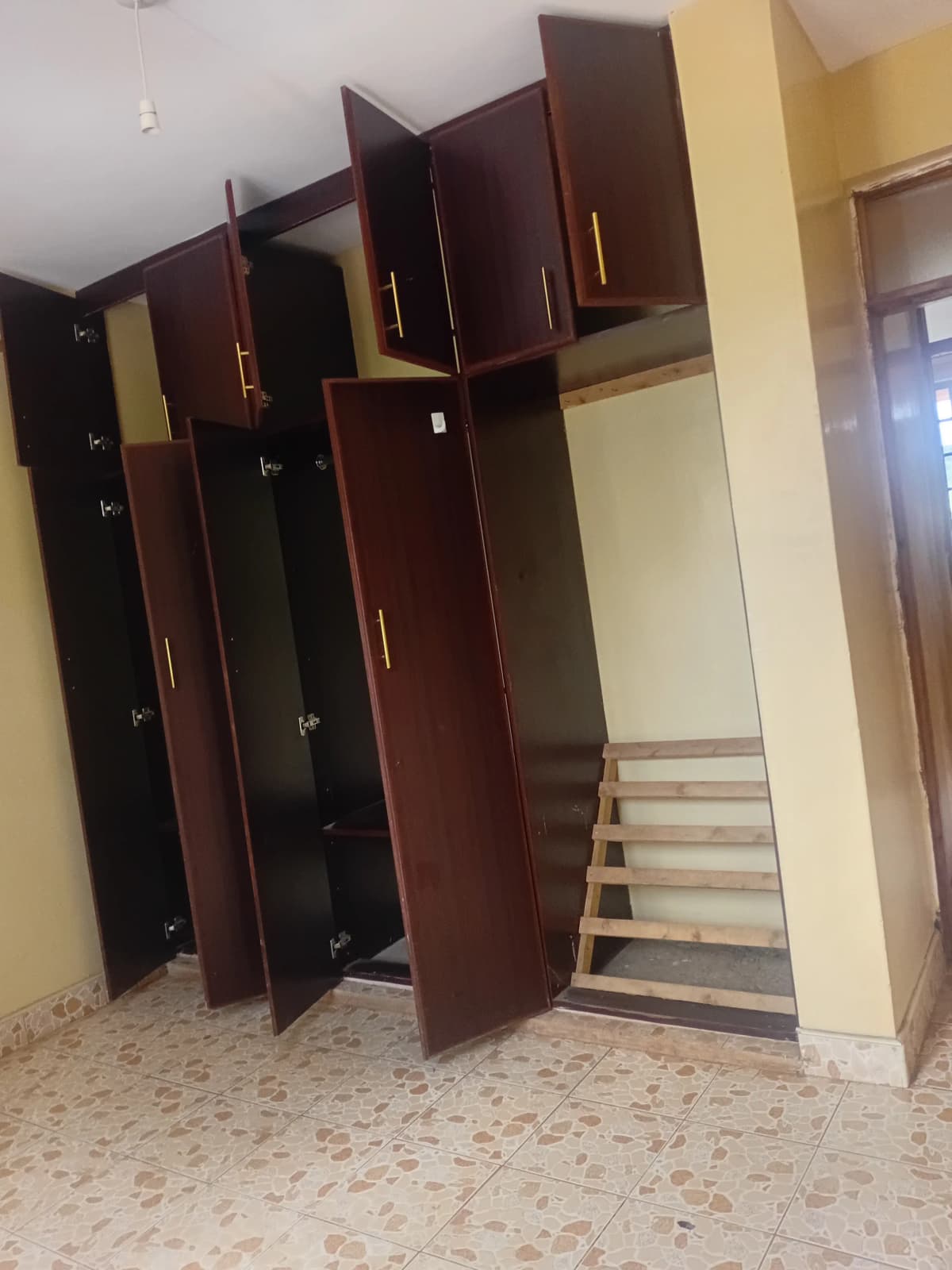 Bedroom with dark wood wardrobes and single bed frame