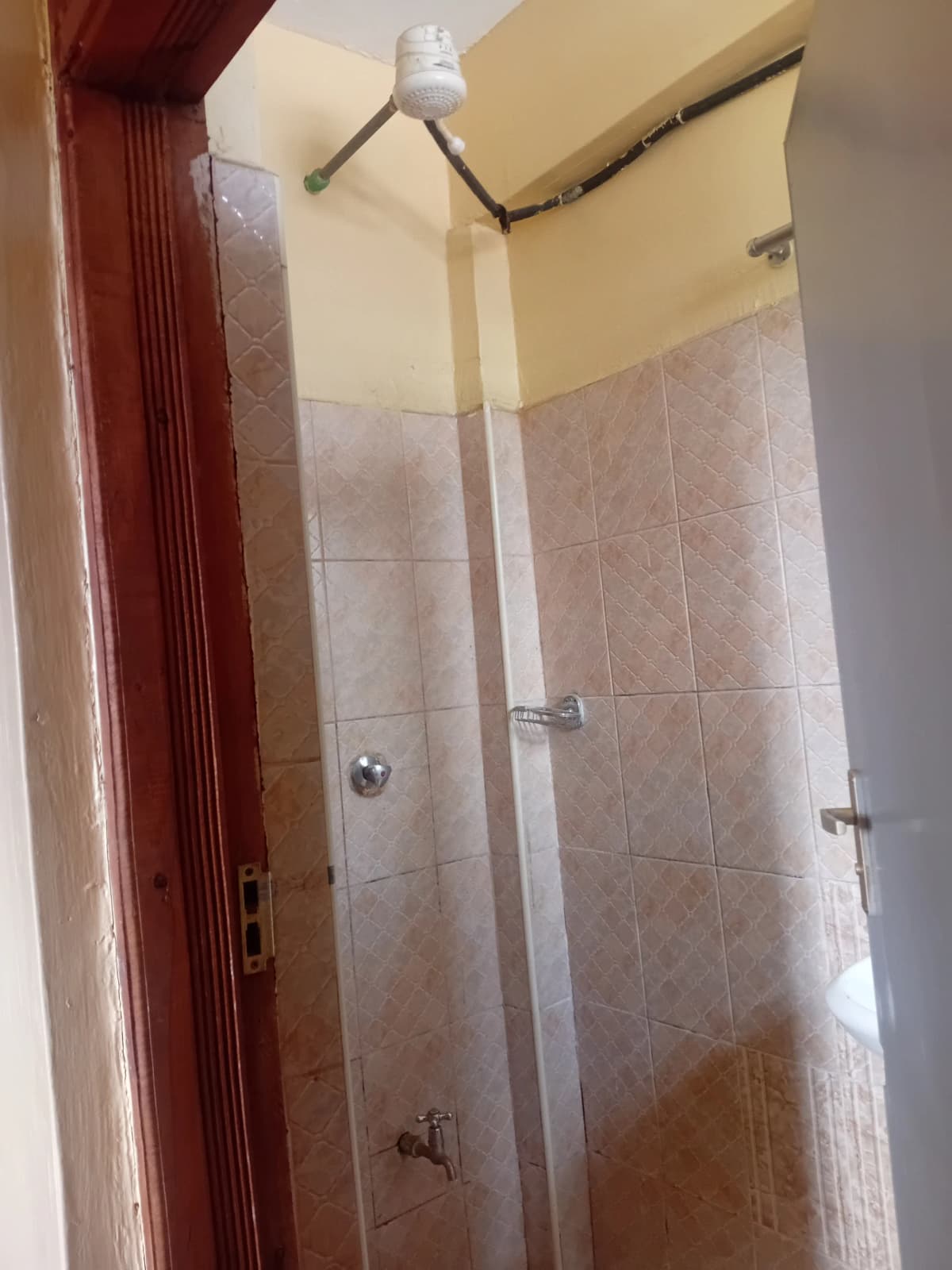 Shower enclosure with tiled walls and overhead shower head
