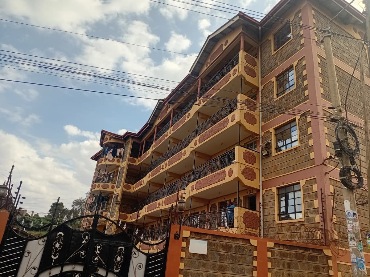 Multi-story residential building facade with stone and brick construction