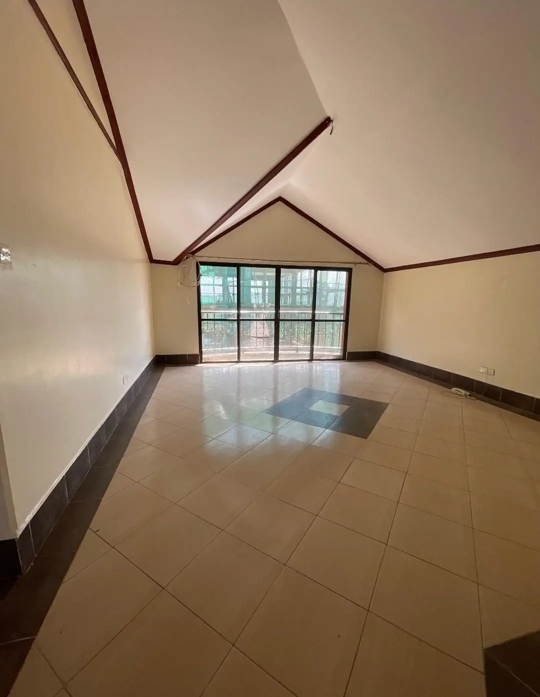 Spacious attic living room with vaulted ceiling and skylight