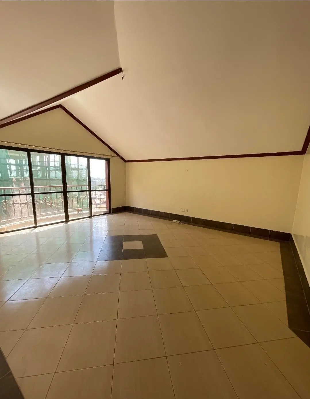 Spacious living room with vaulted ceiling and glass doors