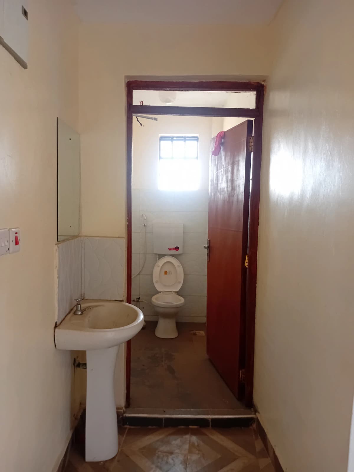 Basic bathroom with pedestal sink and toilet fixture