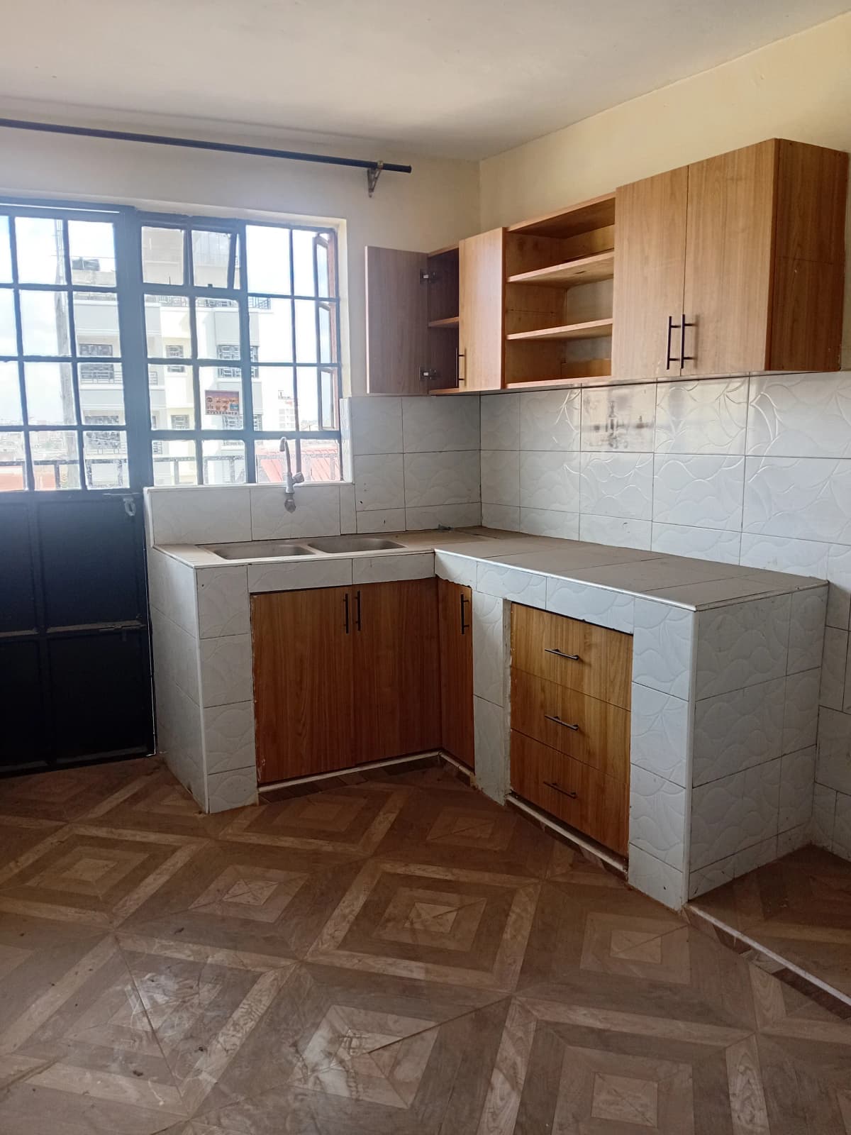 Compact kitchen with wooden cabinets and white tile backsplash