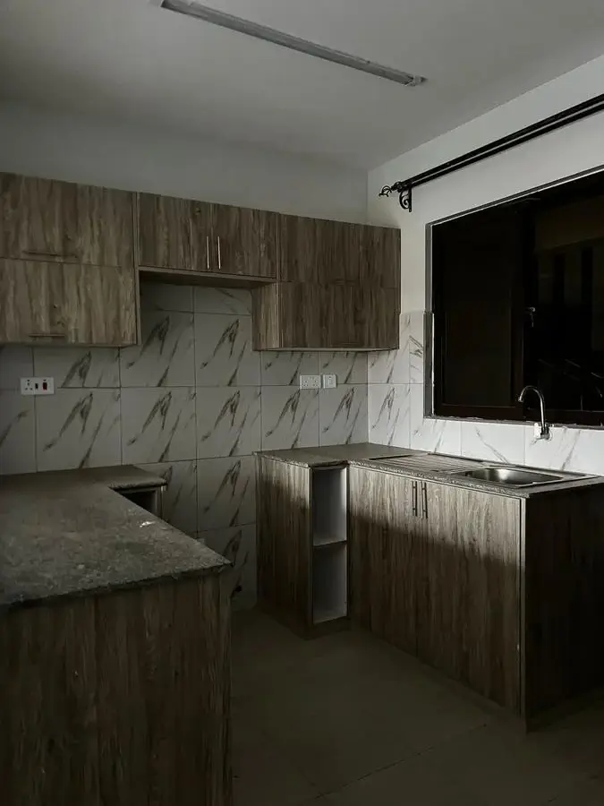 Modern kitchen with marble backsplash and wood cabinetry