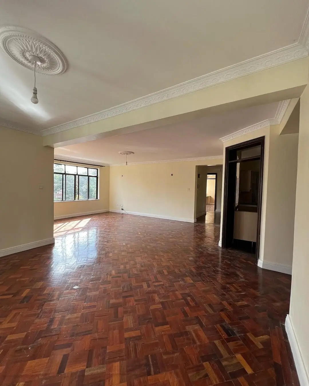 Spacious open-plan living area with herringbone wooden floors