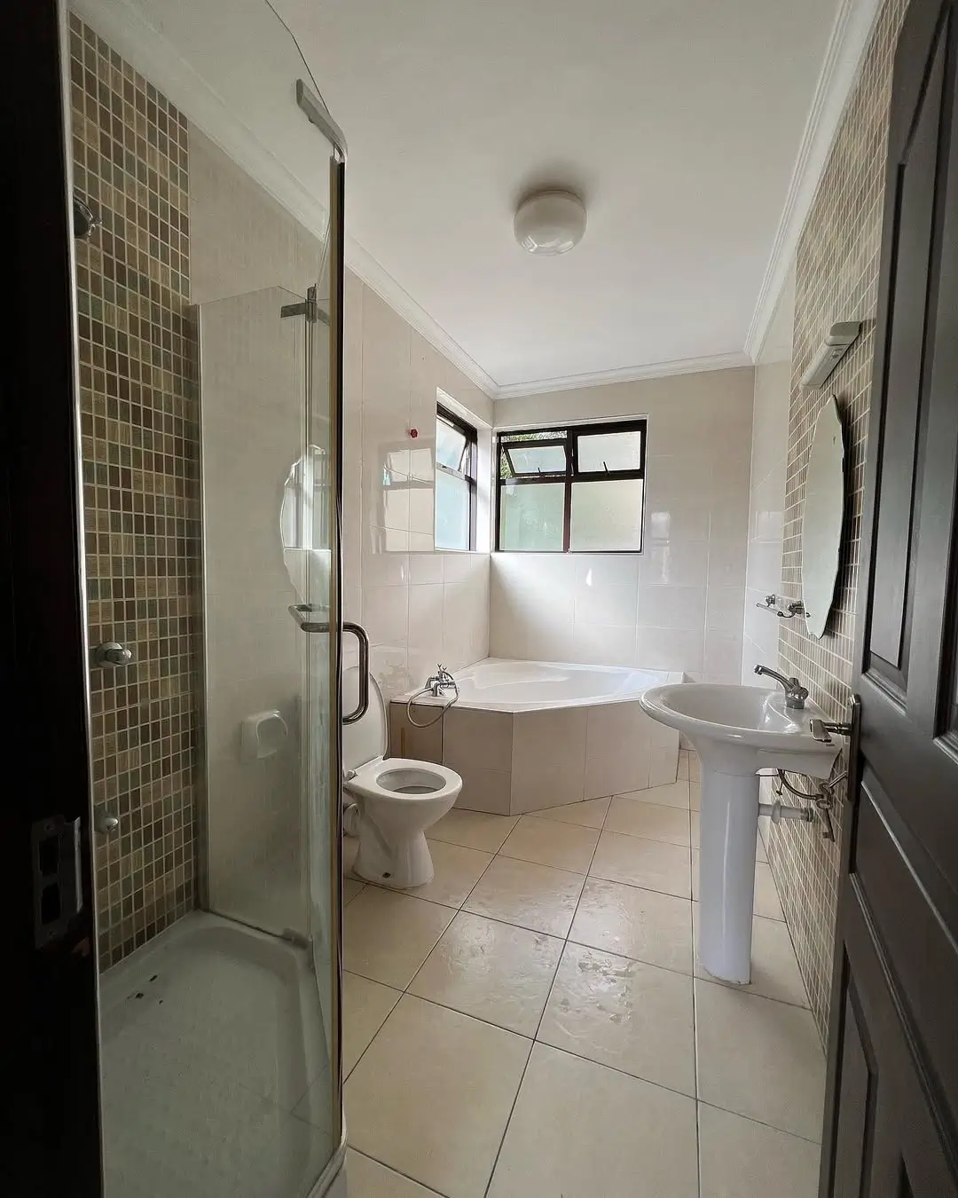 Modern bathroom with shower enclosure, bathtub, and pedestal sink