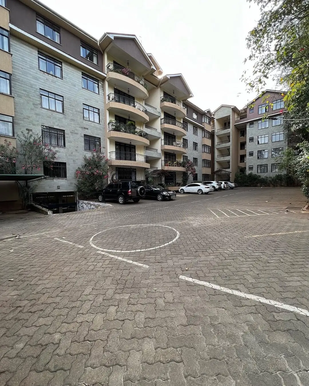 Multi-story residential building with shared parking compound