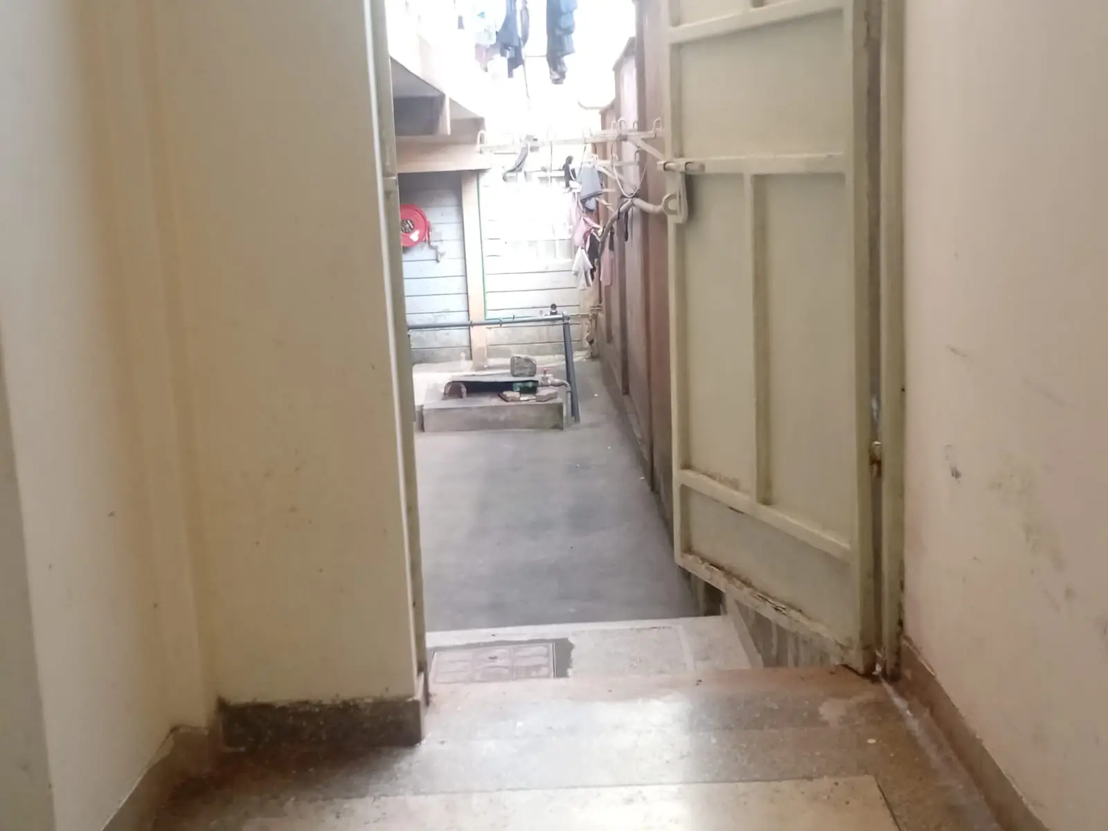 Internal corridor with tiled flooring and neutral walls