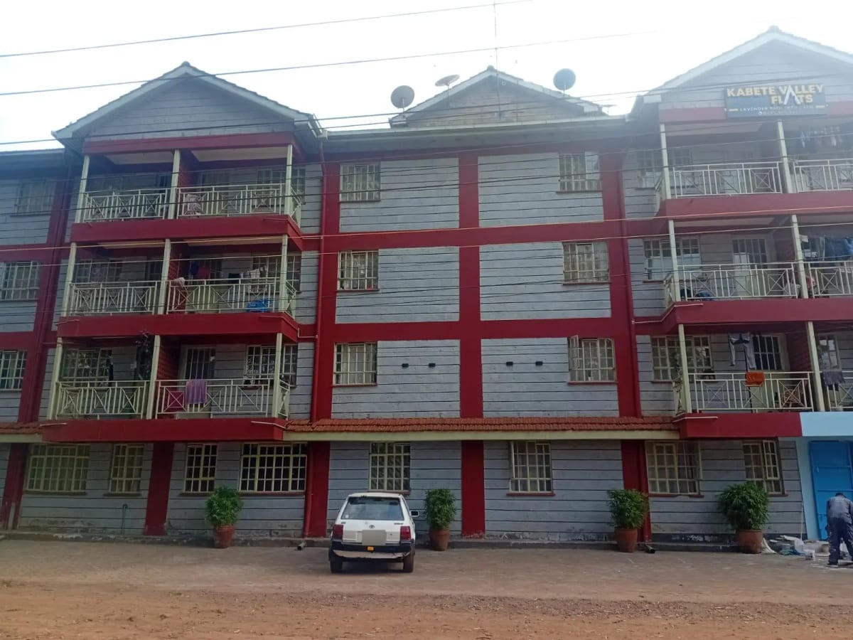 Multi-story residential building with red and white facade