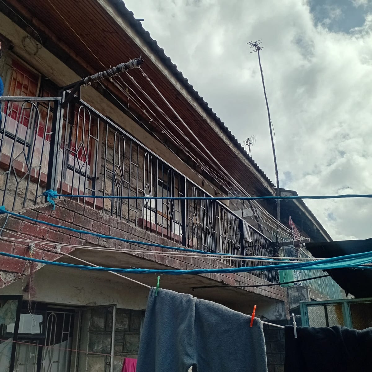 Multi-story building facade with metal railings and clothesline