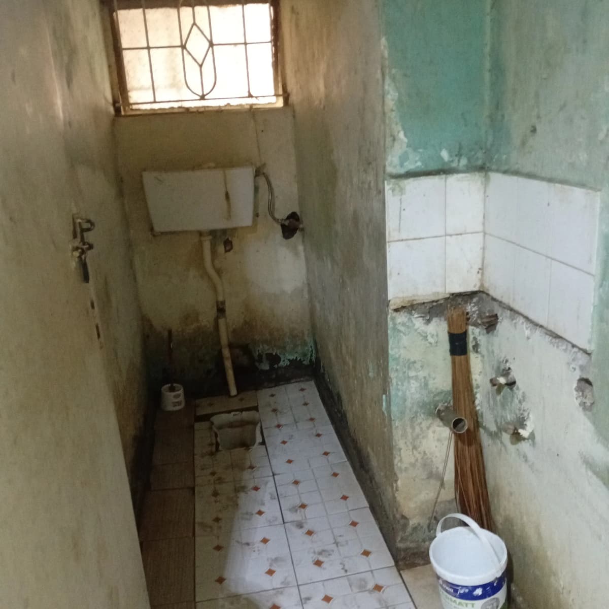 Basic bathroom with deteriorating walls and dated fixtures