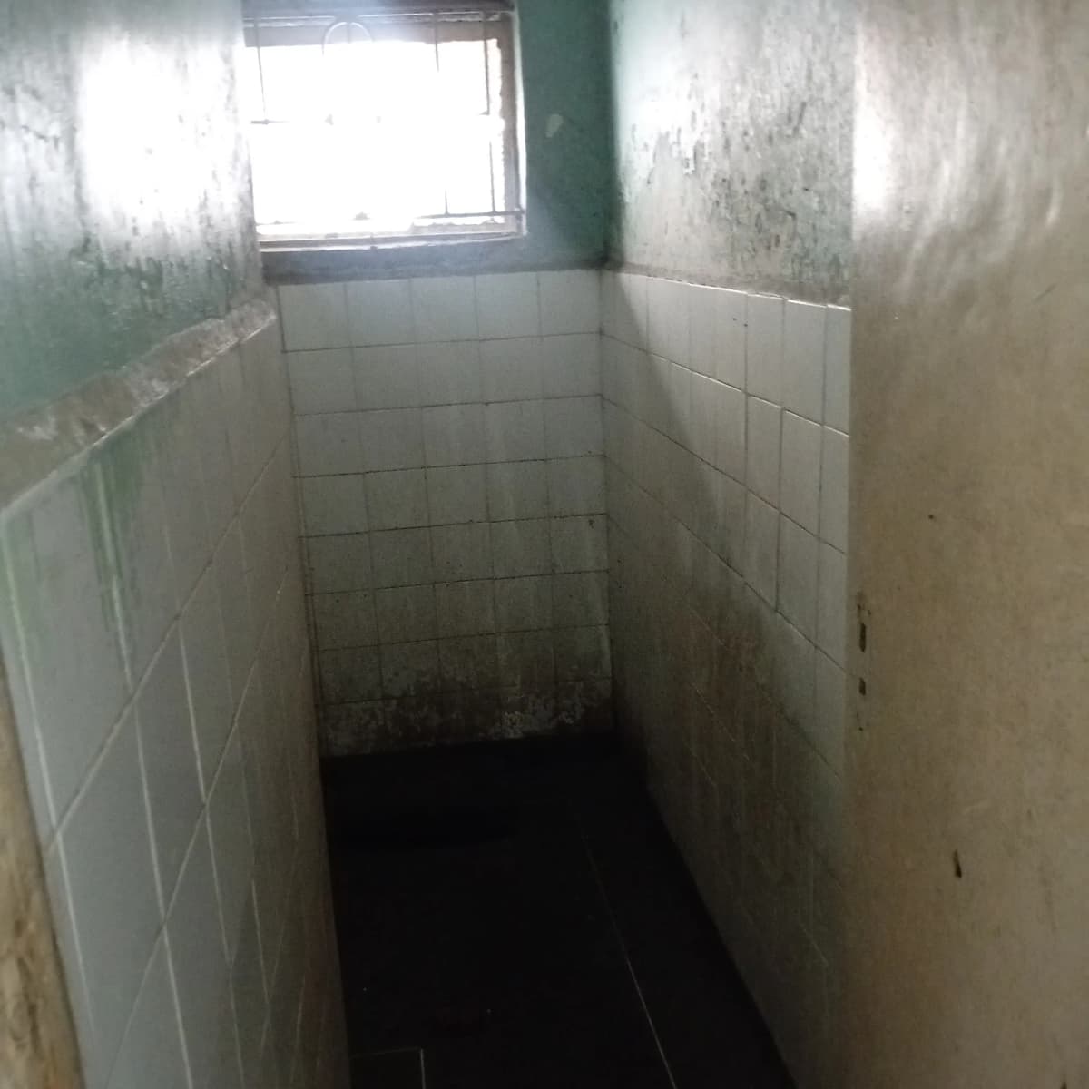 Small bathroom with white tile walls, narrow layout