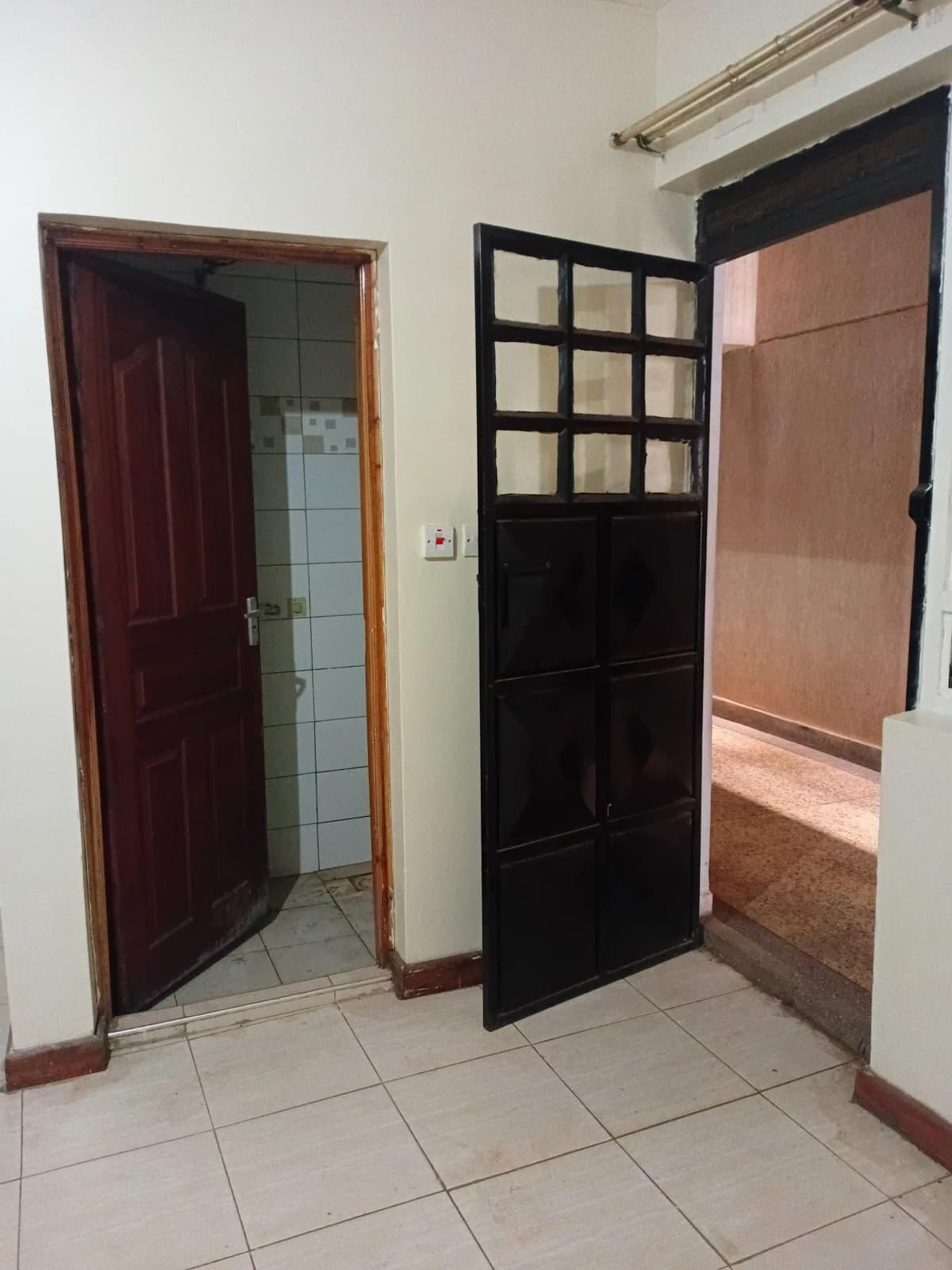 Building corridor with tiled floor and multiple doors