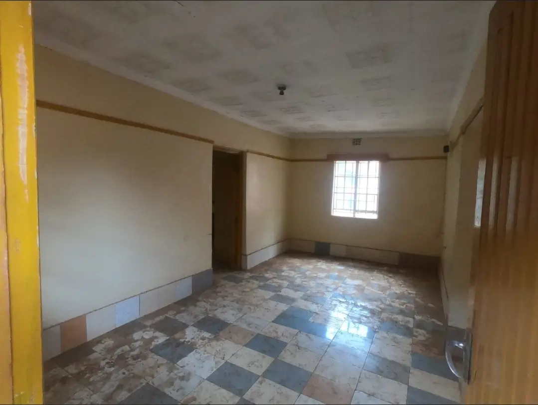 Empty living room with tiled floor and natural light