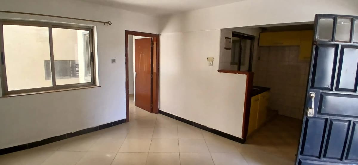 Spacious unfurnished living room with natural light and tiled flooring