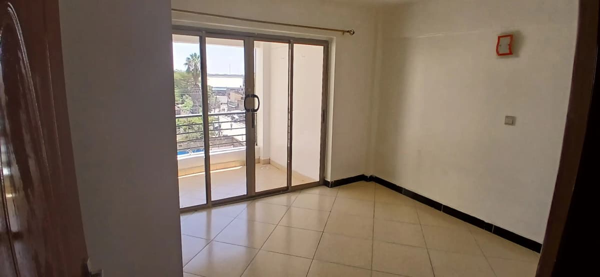 Spacious balcony with sliding glass doors and city views