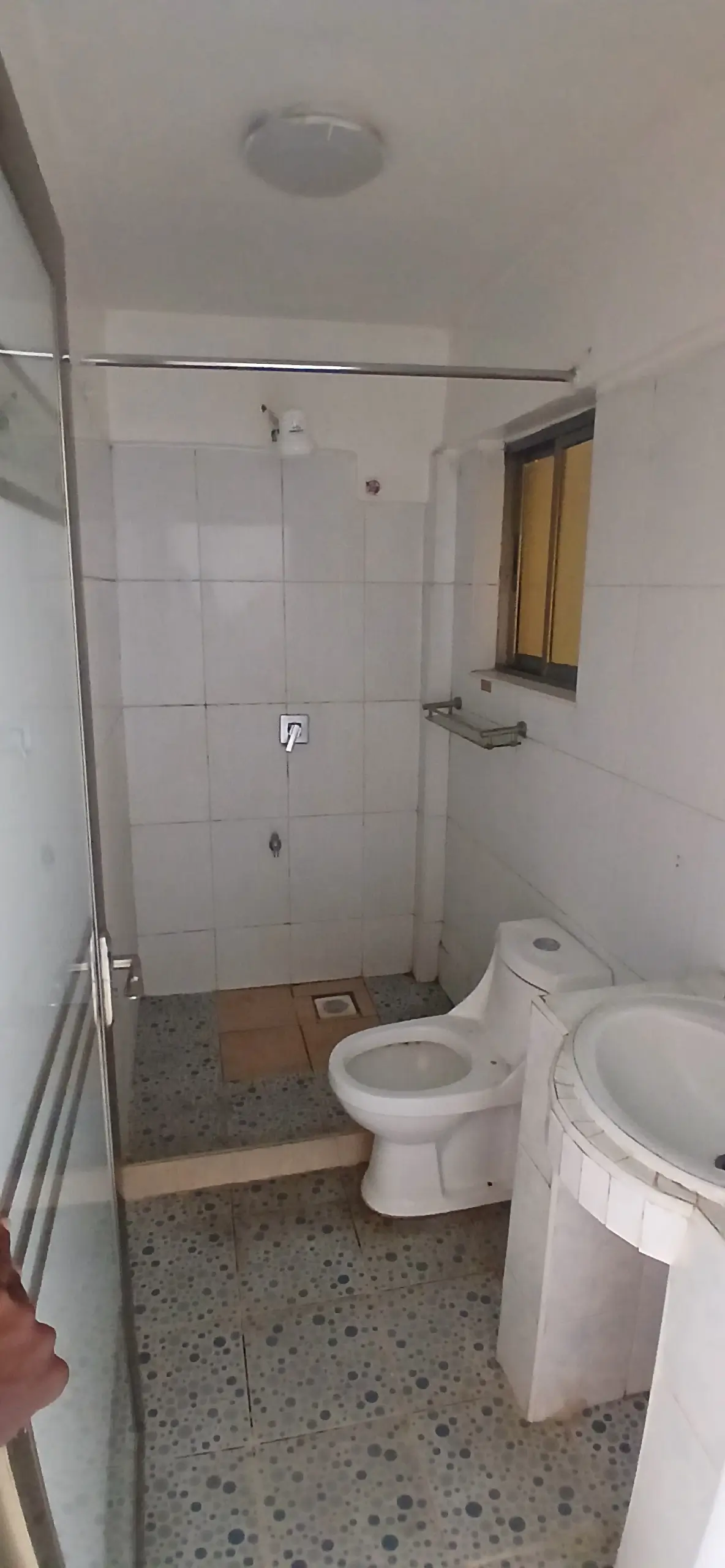 Compact bathroom with walk-in shower and white fixtures
