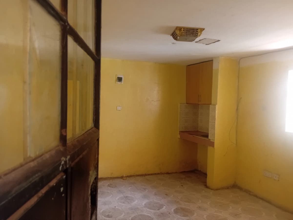 Empty living space with yellow walls and wooden door frame