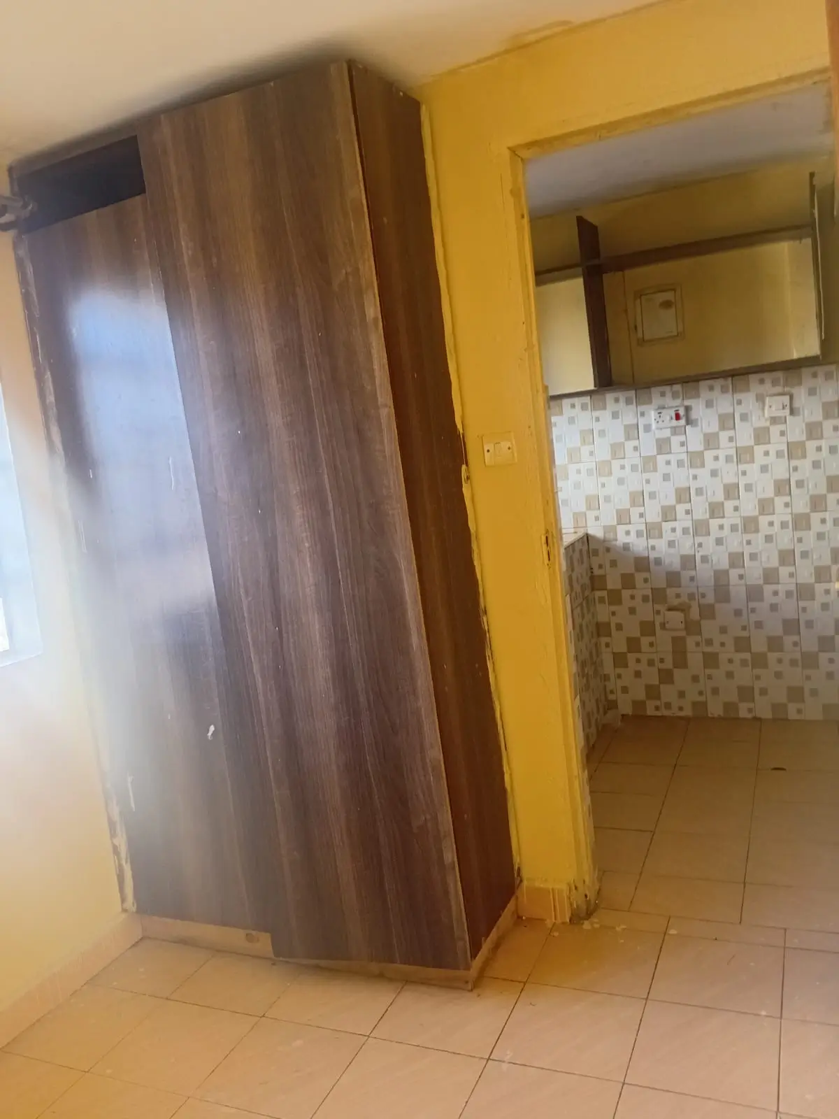 Kitchen with yellow frame and tiled backsplash area