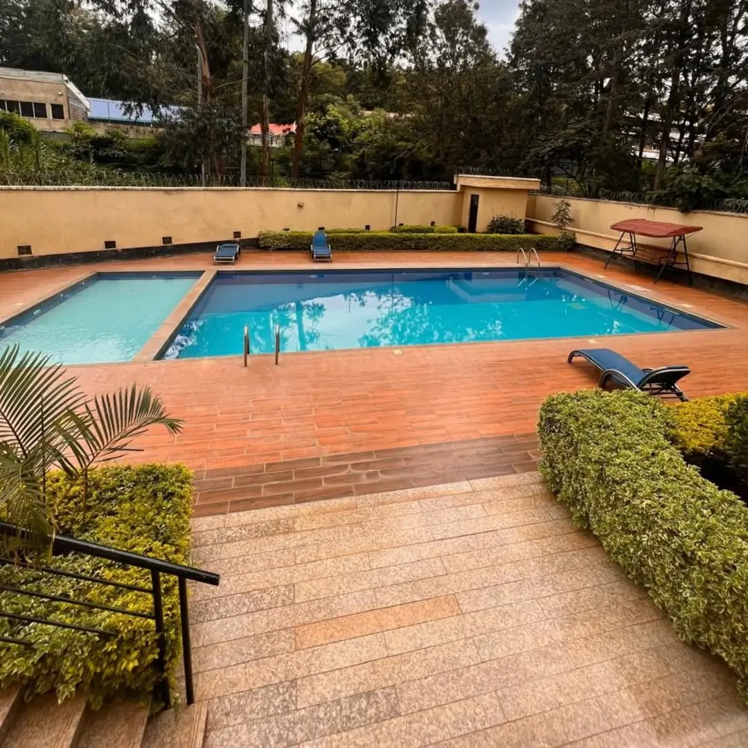 Resort-style swimming pool with terracotta deck and landscaping