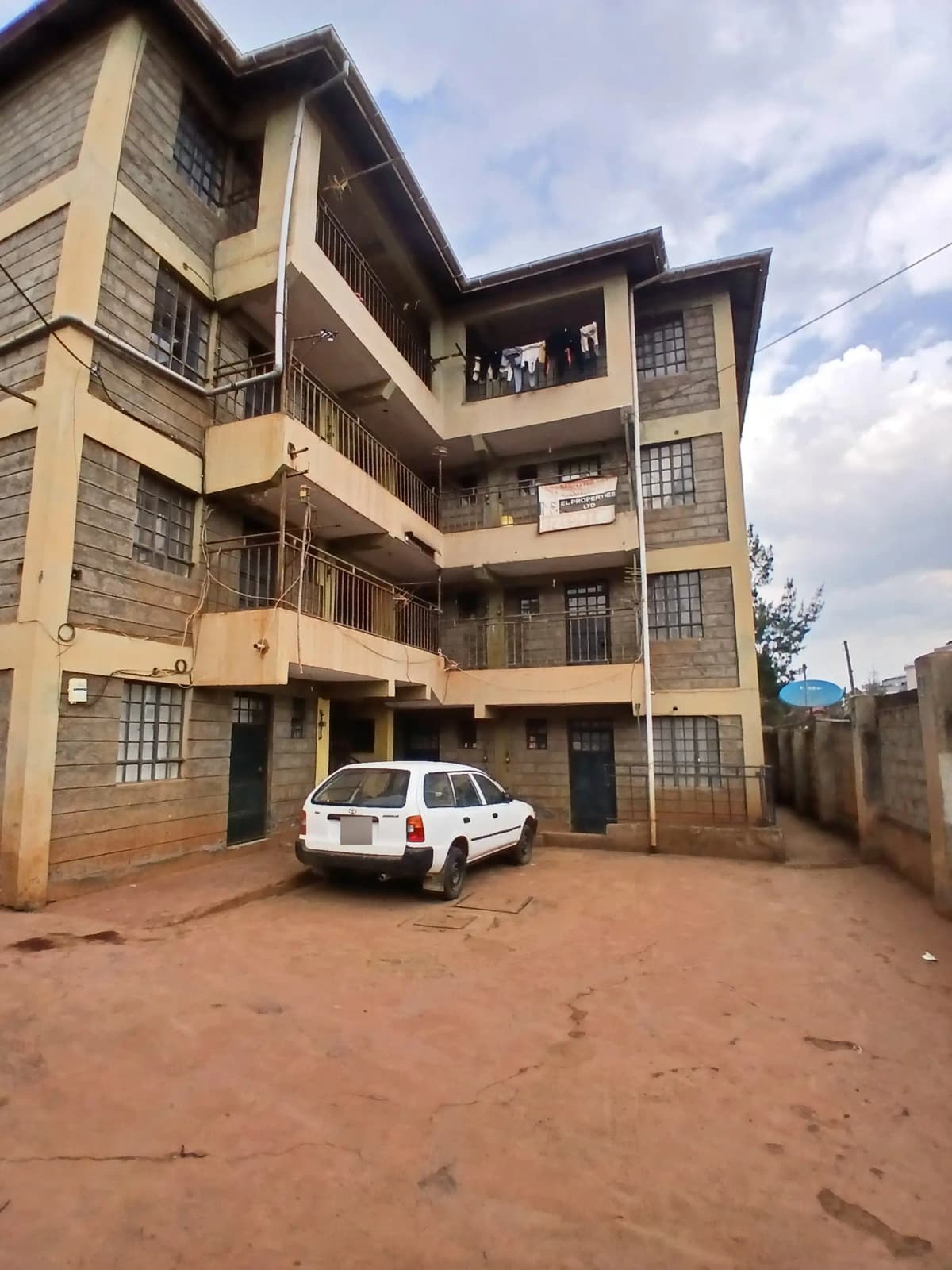 Multi-story residential building with parking compound entrance